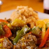 Organic Curry Goat · Marinated in Indian curry cooked then simmer with red potatoes. served with rice peas and st...