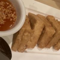 Fried Tofu · firm tofu lightly batters and fried served with
sweet and sour sauce top with crushed peanut.