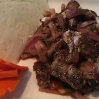 Nam Tok · Sliced beef, cilantro, green onion, red onion, rice powder, mixed and top with mint. Served ...