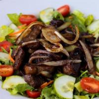 Steak Salad · Prime top sirloin cap (picanha 7 oz), sautéed red onions served on a mixed greens salad with...
