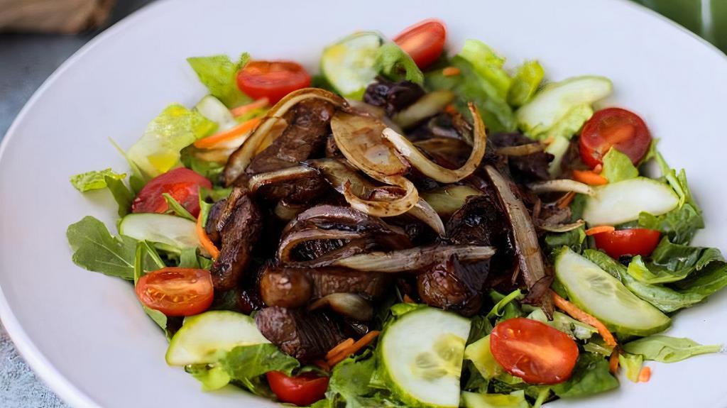 Steak Salad · Prime top sirloin cap (picanha 7 oz), sautéed red onions served on a mixed greens salad with balsamic dressing.