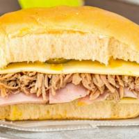 Media Noche Sandwich · Serrano ham, roasted pork, pulled pork, mustard, and kosher dill pickles smothered in German...