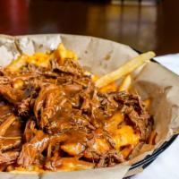 Pot Roast Wet Fries · Juicy pot roast, coated with gravy, over shredded cheddar cheese and Murph's signature fries.