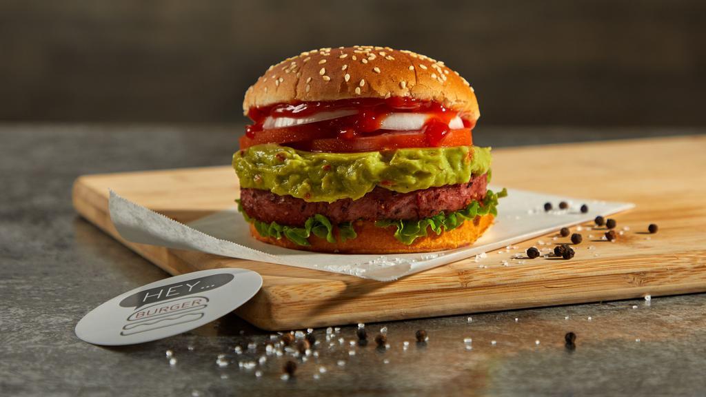Healthy Burger · Beyond burger on a sesame bun topped with lettuce, tomatoes, white onions, pickles, ketchup, and guacamole.