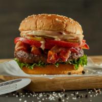 Bacon Burger · Black Angus ground beef burger on a sesame bun topped with bacon, lettuce, tomatoes, white o...