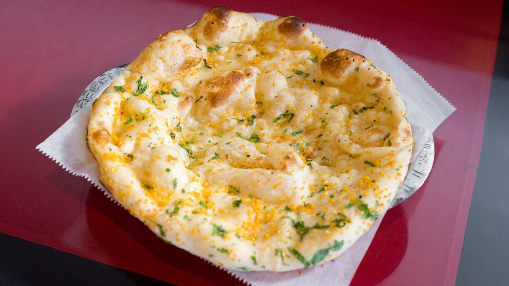 Garlic Naan · Traditional bread seasoned with fresh garlic, baked in the tandoor.