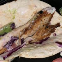 Key West Tacos · Three flour tortillas topped with mahi, avocado, red cabbage, tomatoes, and cilantro lime sa...