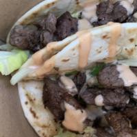 Steak Tacos (2) · Flour tortilla, lettuce, grilled steak and topped off with island sauce