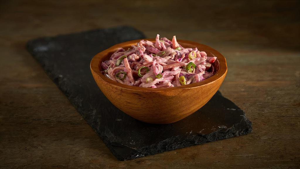 Spicy Coleslaw Salad · Freshly shaved cabbage, carrots, and chives in our homemade Cayenne pepper spicy mayonnaise slaw dressing.
