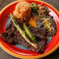 Carne Asada · Served with rice, beans, guacamole and tortillas.