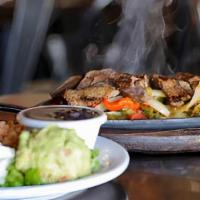 Steak Fajita · Hot skillet filled with peppers, onions, and steak.
Served with lettuce, pico, sour cream, g...
