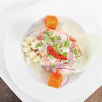 Ceviche Peru (Camarones) · Marinated raw fish and shrimp in fresh lime juice, mixed with onions and coriander.