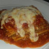 Lasagna · Home made meat lasagna with ricotta cheese in marinara sauce and melted mozzarella cheese on...