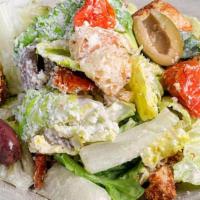 Caesar Salad Side · Romaine hearts, garlic croutons, roasted tomatoes, marinated olives, and freshly grated gran...