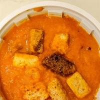 Spicy Tomato Soup · Cup of spicy tomato soup with croutons.