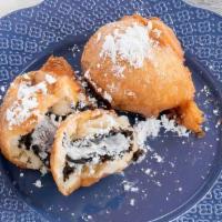 Fried Oreos · Cake Battered Fried Oreos Topped with Powdered Sugar