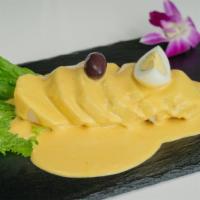 Papa A La Huancaina · Sliced potato topped with hot yellow pepper and white cheese sauce.