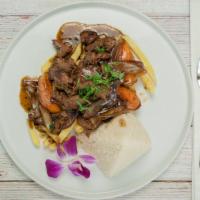 Tacu Tacu Con Lomo Saltado · Rice and beans fried tortilla topped with sauteed beef tenderloin strips, onions and tomatoes.