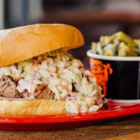 Slawpy Pig · Heaping pile of pulled pork topped with coleslaw. Served on a large bun with one side.