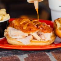 Bird Dog · Our signature smoked turkey topped with a sliced smoked sausage link. Served on a large bun ...