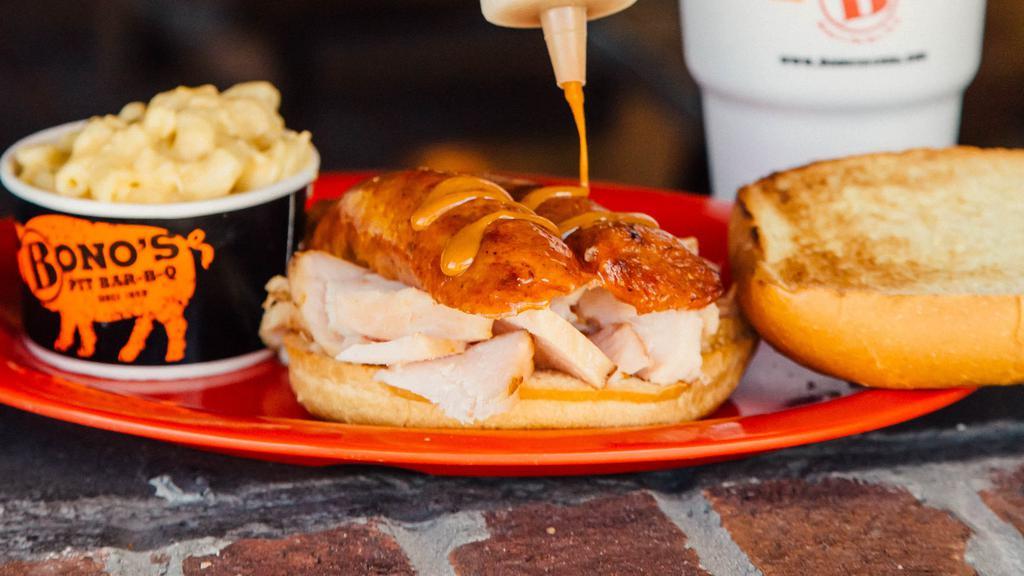 Bird Dog · Our signature smoked turkey topped with a sliced smoked sausage link. Served on a large bun with one side.