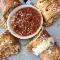 Buffalo Chicken Stromboli · Our dough rolled and stuffed with grilled chicken, mangia wing sauce, blue cheese dressing a...
