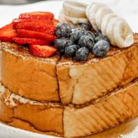 French Toast With Fresh Fruit · challah bread topped with fruits and pure maple syrup.