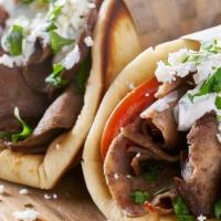 Lamb Gyro · Sliced lamb set on pita bread topped with lettuce, tomatoes, onions and tzatziki sauce.