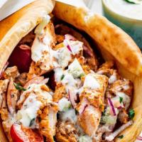 Chicken Gyro · Sliced chicken set on pita bread, topped with lettuce, tomatoes, onions, and tzatziki sauce.