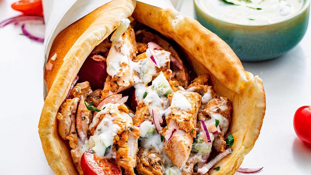 Chicken Gyro · Sliced chicken set on pita bread, topped with lettuce, tomatoes, onions, and tzatziki sauce.