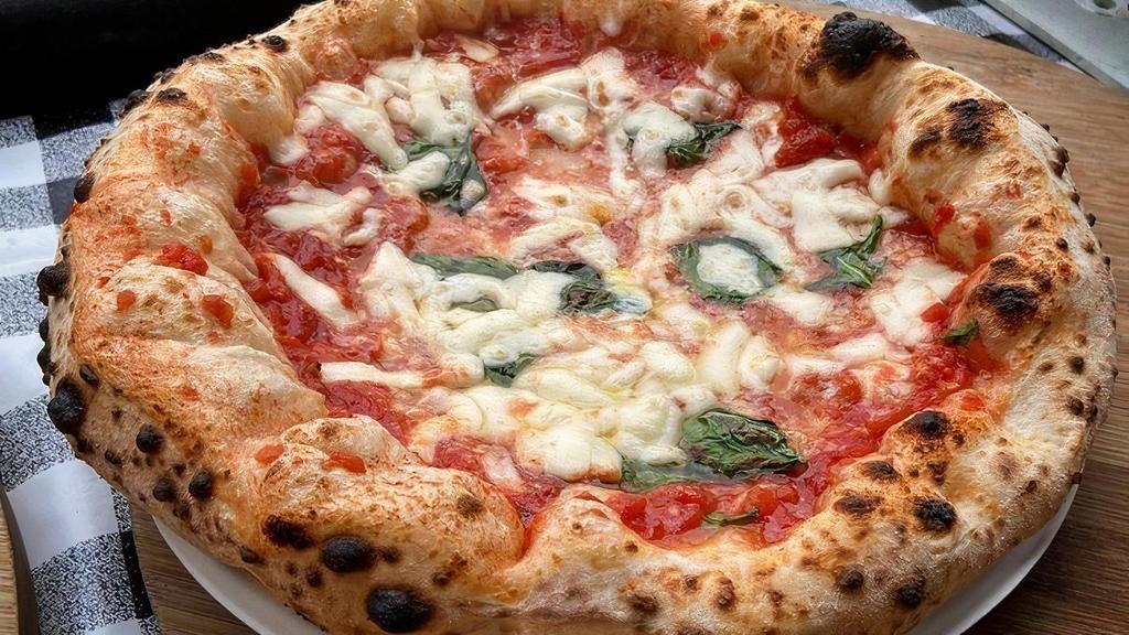Margherita Pizza · Tomato Sauce, Basil, Mozzarella and Olive Oil