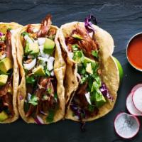 Pork Carnitas Taco · A taco filled with pork carnitas, lettuce, tomatoes, cheese and sauce.