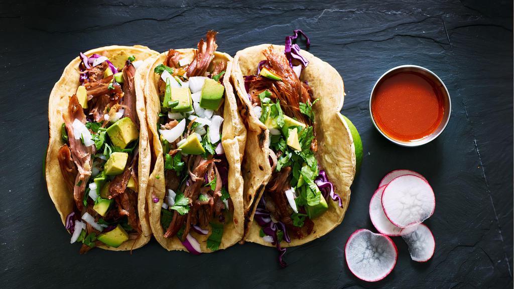 Pork Carnitas Taco · A taco filled with pork carnitas, lettuce, tomatoes, cheese and sauce.