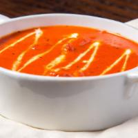 Butter Chicken · Classic tandoor grilled chicken in mildly spiced tomato gravy enriched with butter and cream...