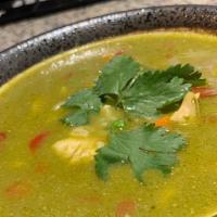 Aguadito De Pollo · Soup with chicken breast chunks, peas, carrots, corn, red peppers and rice in our cilantro s...