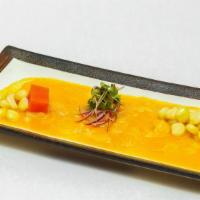 Tiradito Alaji Amarillo · Corvina sashimis topped with aji amarillo sauce and lime juice, served with sweet potatoes a...