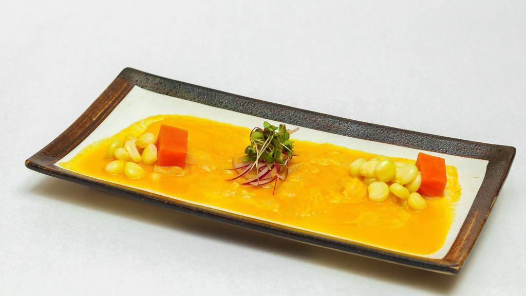Tiradito Alaji Amarillo · Corvina sashimis topped with aji amarillo sauce and lime juice, served with sweet potatoes and corn.