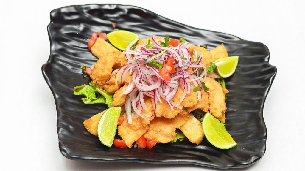 Chicharron De Pescado · Crispy fish pieces perfectly marinated, served with fried yucas, salsa criolla and tartar sauce.