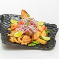 Jalea Personal Mixta · Crispy pieces of fish and seafood topped with salsa criolla and golden yuca with a tartar sa...