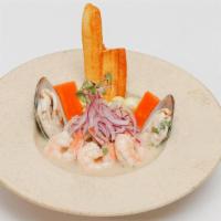 Ceviche Mixto · Seafood mix perfectly marinated, served with sweet potatoes slices and Peruvian corn.