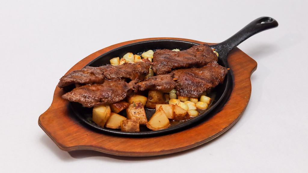 Anticuchos De Corazon · Tender pieces of veal heart marinated in Peruvian spices served with potatoes and corn.