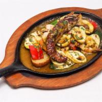Mariscos Al Grill · Grilled shrimps, calamari, mussels and octopus tentacle in our chimichurri criollo sauce ove...