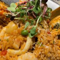 Arroz  Con Mariscos · Traditional Peruvian style paella with shrimps ,calamari ,octopus ,mussels ,scallops ,peas c...