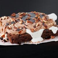 Mocha Mud Pie Brownie · Decadent fudge brownie topped with decadent whipped cream, rich mocha frosting, toasty pecan...