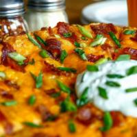 Pizza Skins · Roasted Garlic Mashed Potatoes, Cheddar Cheese, Applewood Smoked Bacon, Scallions, and Sour ...