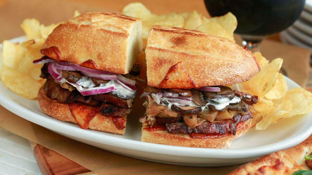 Steak & Cheese · Marinated Steak, Provolone Cheese, Caramelized Onions, Red Onions, Roasted Mushrooms, and Horseradish Crema.
