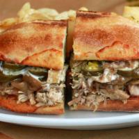 Cuban Pulled Pork · Slow-Roasted Pulled Pork, Provolone Cheese, Caramelized Onions, Jalapeños, and Garlic Aioli.