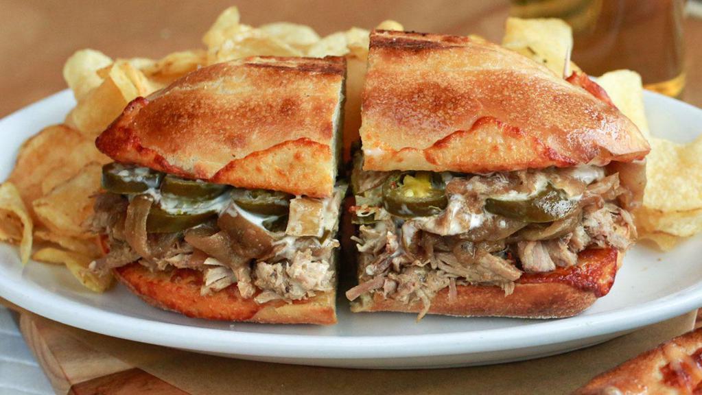 Cuban Pulled Pork · Slow-Roasted Pulled Pork, Provolone Cheese, Caramelized Onions, Jalapeños, and Garlic Aioli.