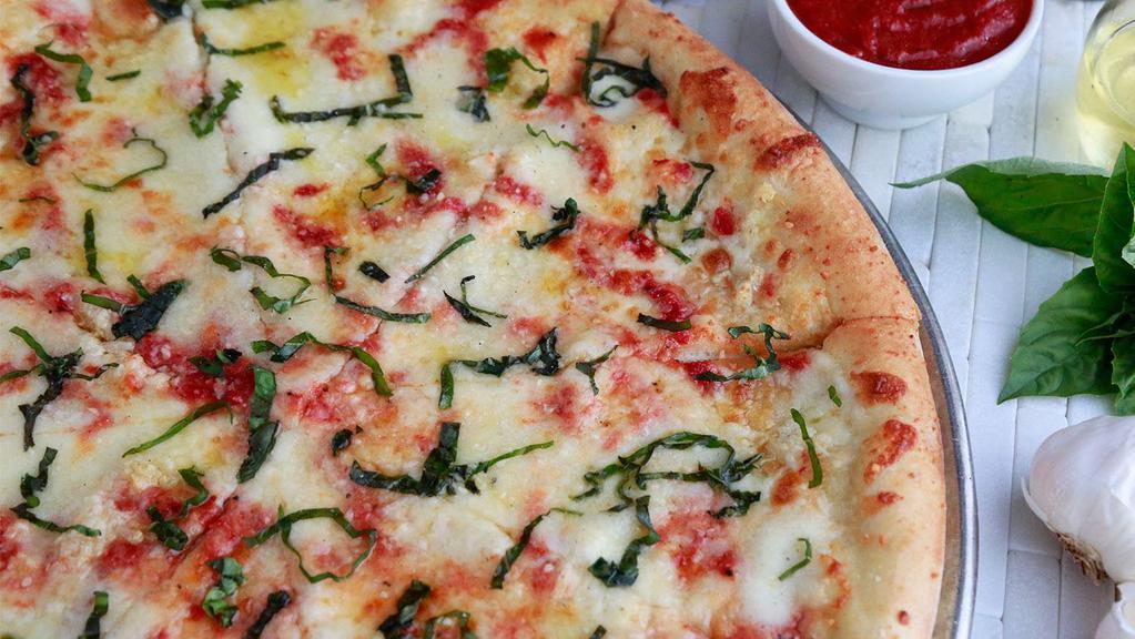 Margherita Pie · Fresh Mozzarella, Fresh Basil, Grated Parmesan Cheese, Olive Oil, Fresh Garlic, and our house-made Pizza Sauce.