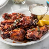 Wings · Sweet and spicy wood fired wings with calabrian pepper honey, and zesty sauce